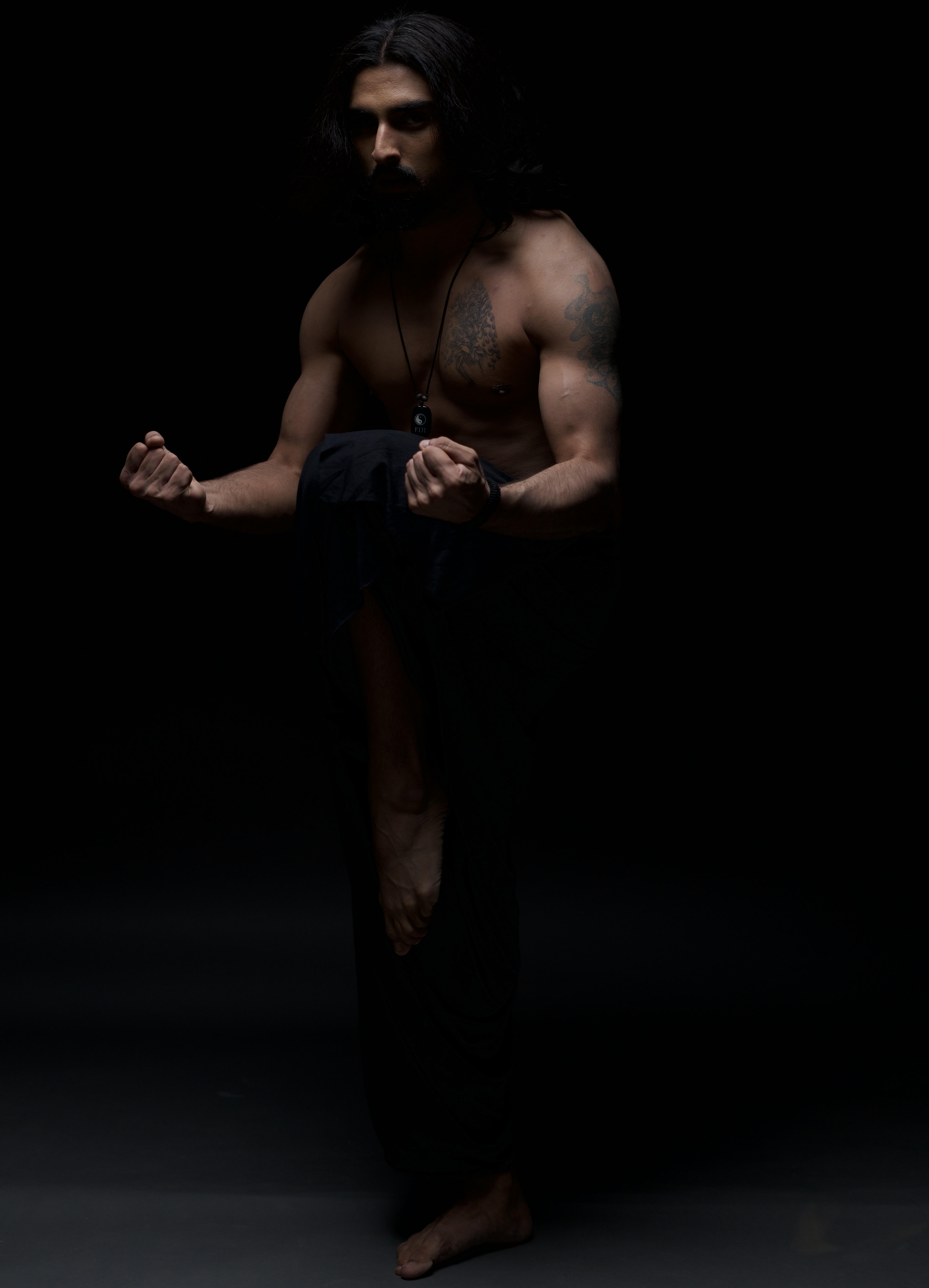 Rishi Sharma &mdash; solo Chhau stance in darkness